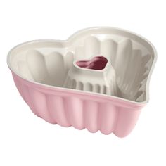 a pink and white heart shaped dish on a white background