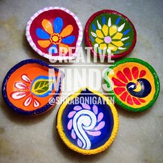 four colorful painted plates sitting on top of a table next to each other with the words creative