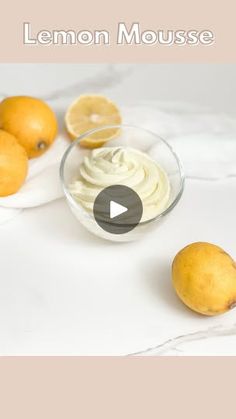 lemon mousse in a glass bowl next to sliced lemons