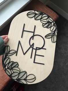 a wooden sign with the word home on it