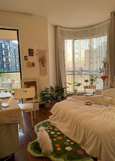 a bed room with a neatly made bed next to a window and a rug on the floor