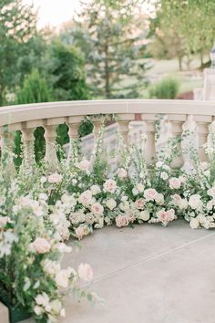 wedding flowers are arranged on the balcony railing