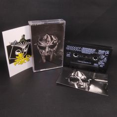 two cassettes, one with a skull on it and the other with a ring