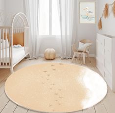 a baby's room with a white crib, rocking chair and large round rug