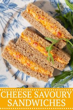 cheese savoury sandwiches on a blue and white plate with green sprigs