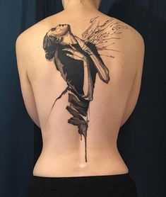 the back of a woman's body with a tattoo on it