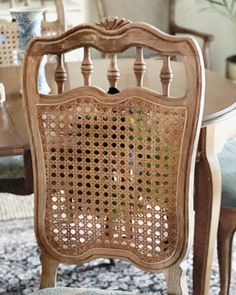 a dining room table with chairs and a rug on the floor