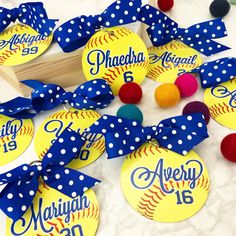 softball themed birthday party favors with polka dots and blue bows on white marble table top