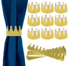 several crowns are placed next to each other on a blue cloth with gold trimmings