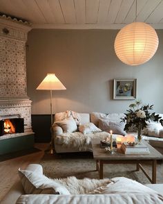 a living room filled with furniture and a fire place in the middle of the room