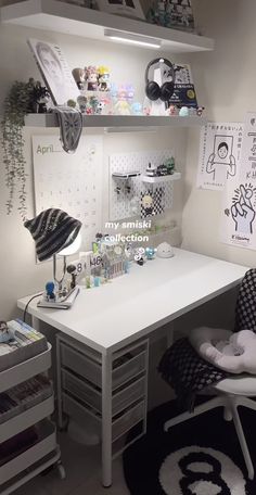 a white desk topped with a chair next to a shelf filled with lots of clutter