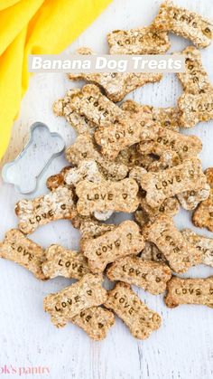 dog treats are laid out on a white surface with a yellow towel next to it