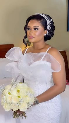 a woman in a wedding dress holding a bouquet