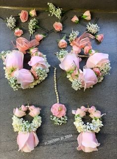 pink roses and baby's breath are arranged on the ground