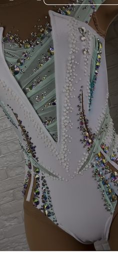 the back of a woman's bodysuit with beads and sequins on it