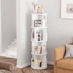 a white corner book shelf in a living room