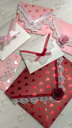 valentine's day cards and envelopes are laid out on a table