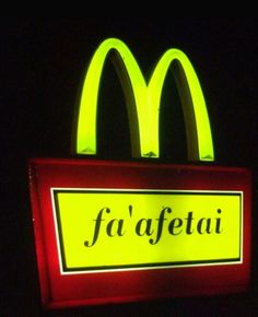 a neon sign that says fa'afetai in front of a mcdonalds