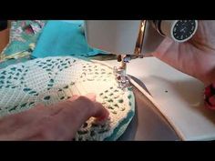 someone is using a sewing machine to sew something on a piece of cloth that has been crocheted