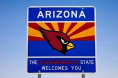 the arizona cardinals state welcomes you sign in front of a blue sky with red, yellow and orange colors