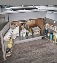 an open cabinet in the middle of a kitchen