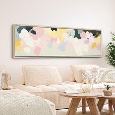 a living room filled with furniture and a large painting on the wall above the couch