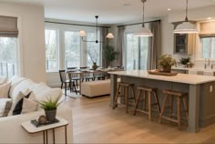 a kitchen and living room are shown in this image, with an island countertop