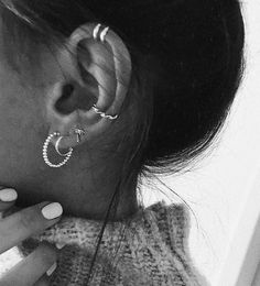 black and white photograph of woman with ear piercings