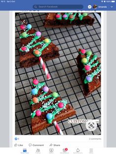 several pieces of cake on a cooling rack with candy canes and candies in them