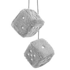 two fuzzy dices hanging from strings against a white background, one is grey and the other has white polka dots