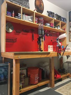 a workbench with lots of tools and other items on it in a garage