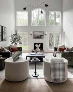 a living room filled with furniture and windows