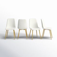 three white chairs sitting next to each other