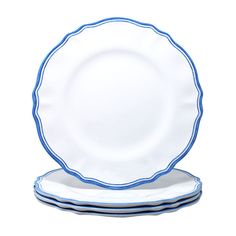 blue and white plates stacked on top of each other in front of a white background