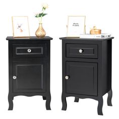 two black nightstands side by side with flowers on top and pictures on the bottom