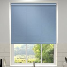 a blue roller shade in a kitchen window