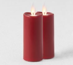 two red candles sitting next to each other