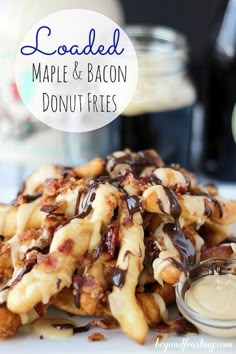 loaded maple and bacon donut fries on a white plate with a jar of sauce