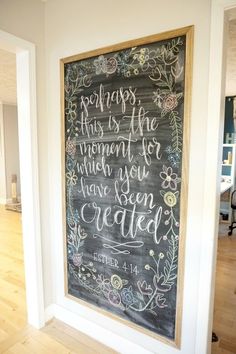 a chalkboard with the bible verse written on it in front of an open doorway