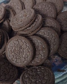 a glass bowl filled with chocolate cookies on top of a table