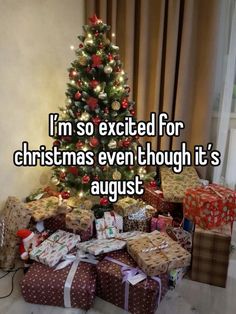 a christmas tree with presents under it and the words i'm so excited for christmas even though it's august