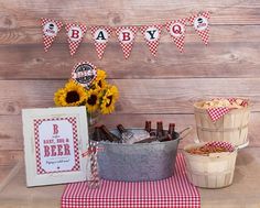 a baby shower party with sunflowers, beer bottles and gingham paper