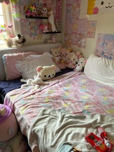 there are many stuffed animals on the bed in this small child's room with pink walls