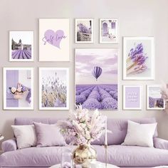 a living room filled with purple furniture and pictures on the wall above it's coffee table