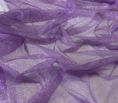 purple sheer mesh fabric with small dots on the top and bottom, as well as some white