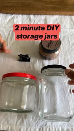 two mason jars are sitting on top of a white towel with the words 2 minute diy storage jars