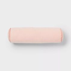 a rolled up pink pillow on a white background