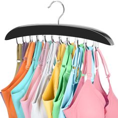 an assortment of bras hanging on a hanger in front of a white background