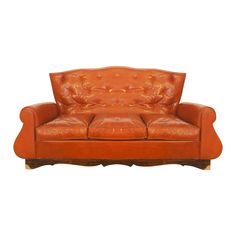 an orange leather couch with wooden legs