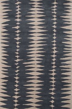 a brown and white rug with an abstract design on the bottom, in front of a white background